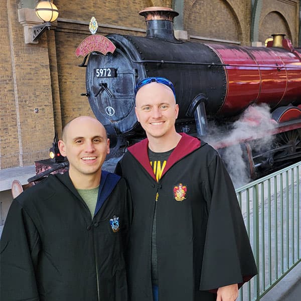 Ryan and Derek standing in front of the Hogwarts Express at Universal Studios.
