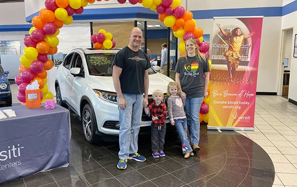 Jonathan and his family, one of the four lucky blood donors who won a car last year.
